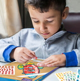 little boy enjoying the stickering activity