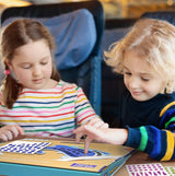 Kids enjoying the stickering activity